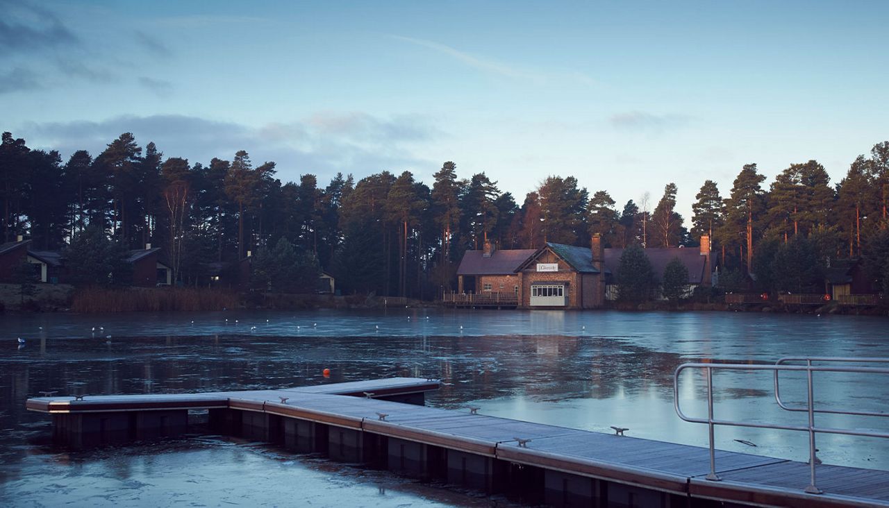 A pier over the lake with the Lakeside Inn restaurant in the background