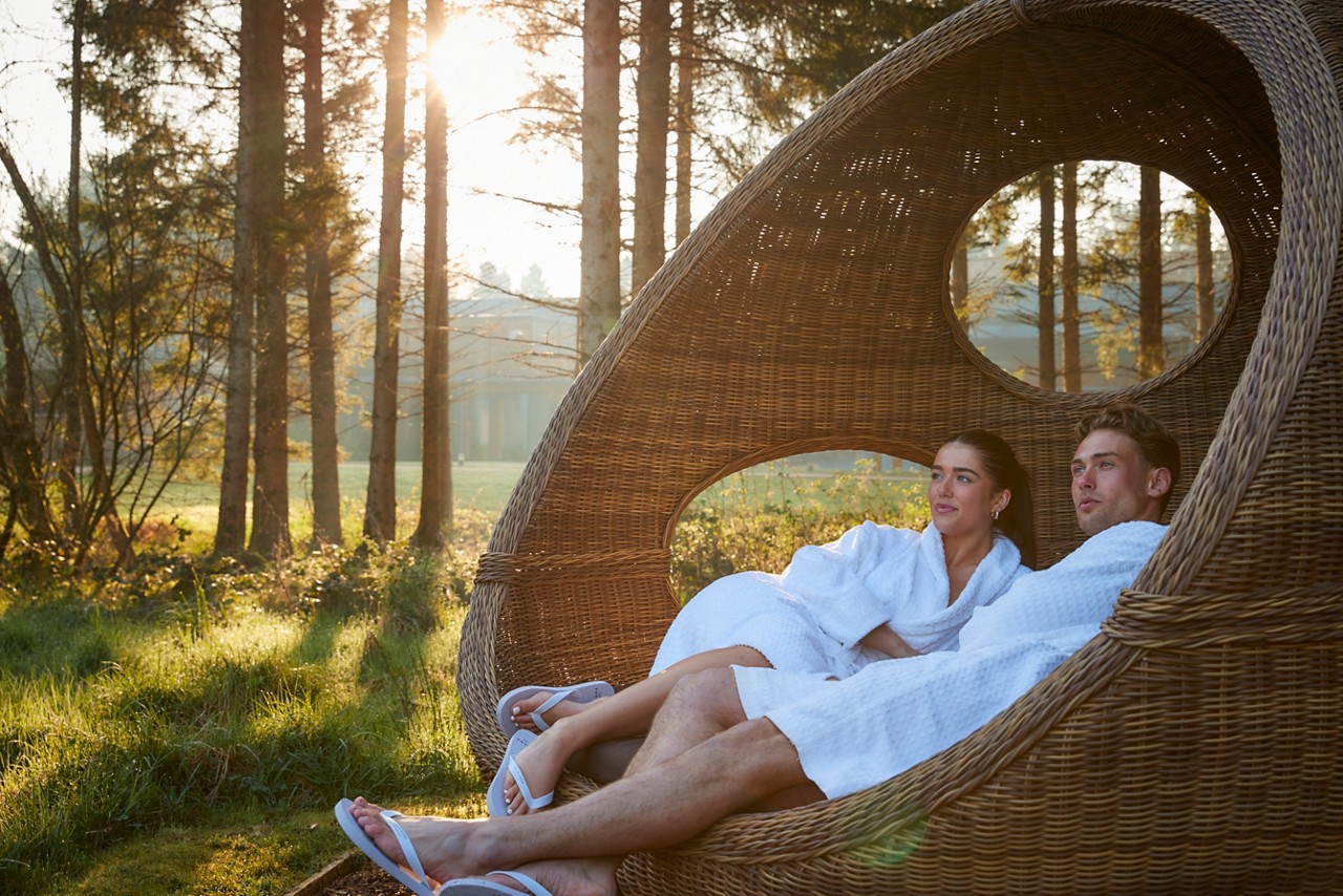 Woman leaning on the edge of an outdoor hot tub.
