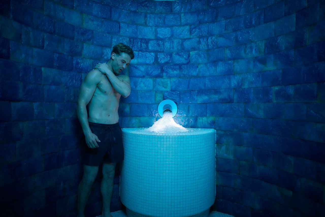 Woman applying ice to her skin.