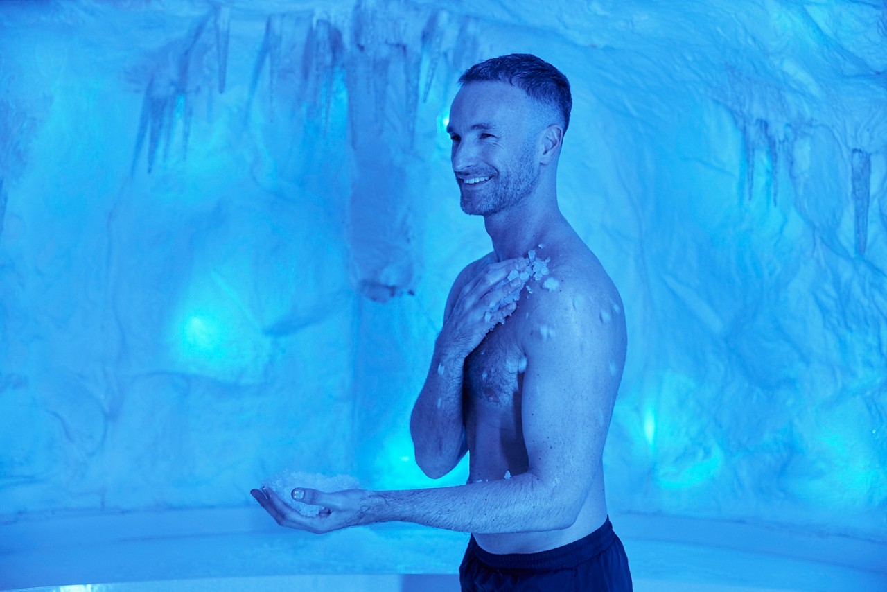Man rubbing ice across his chest.