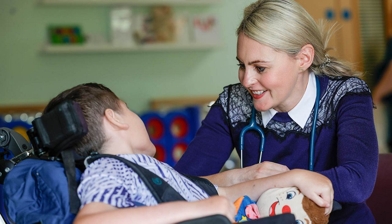 A helper talking to a young boy