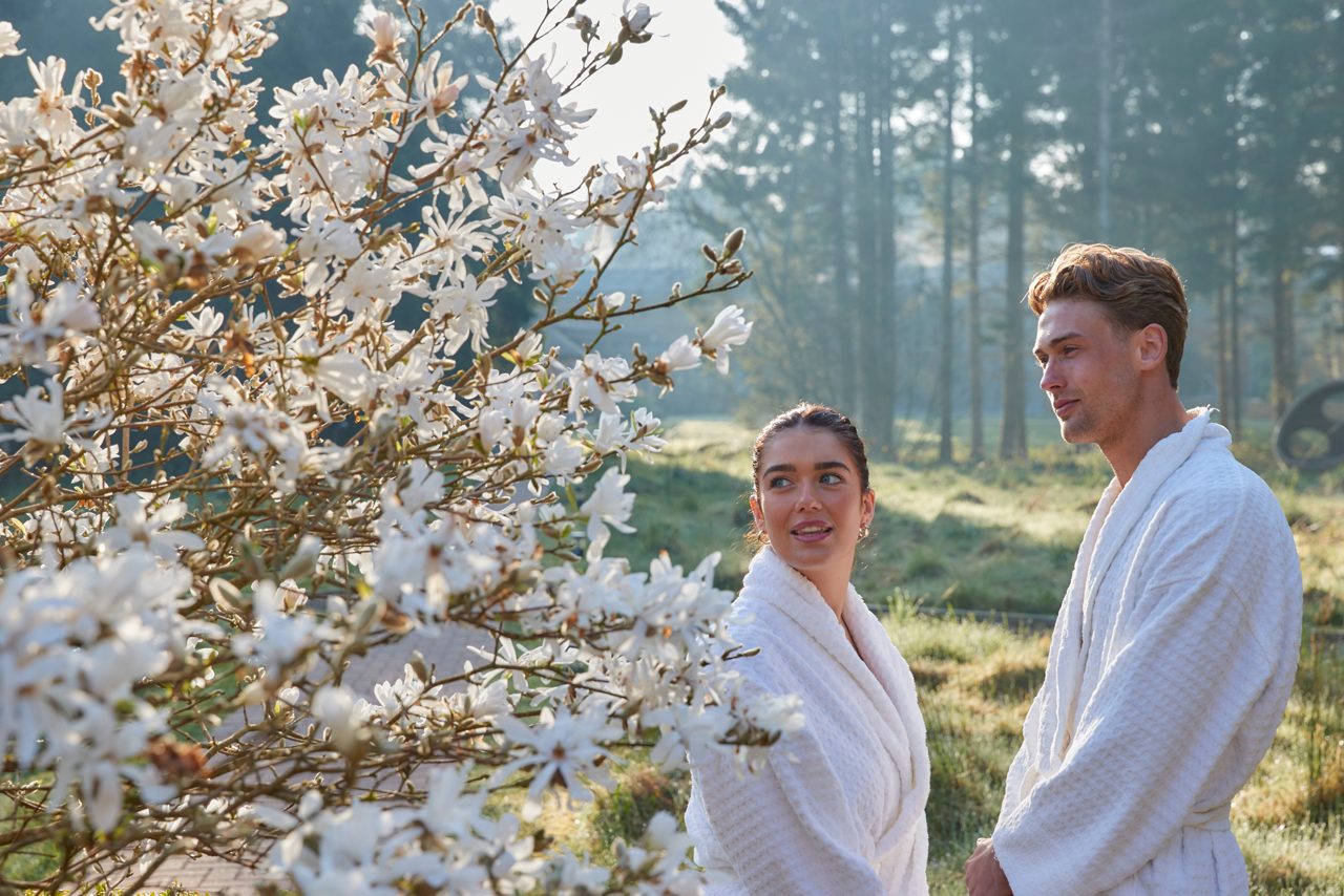 couple in robes by blossom