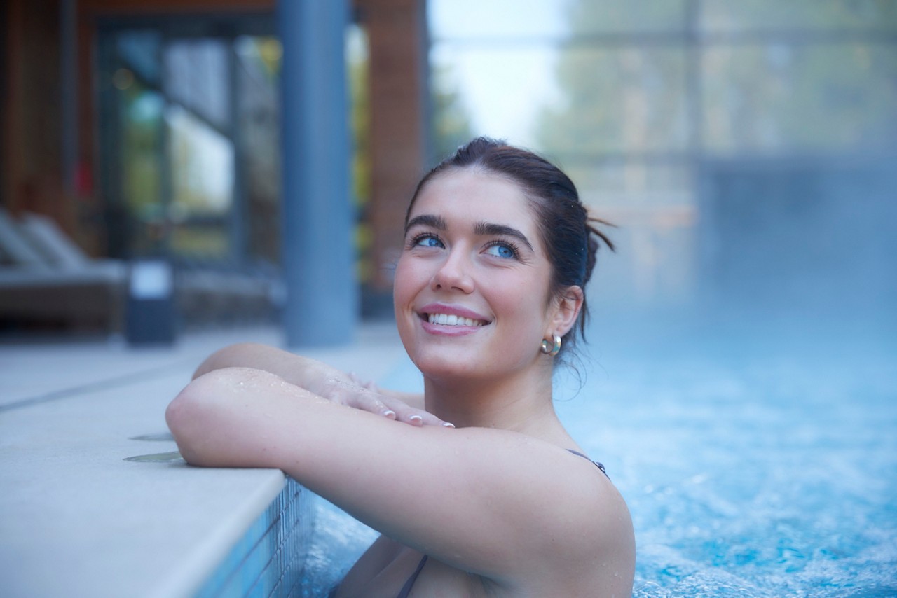 Two people smiling in a hot tub