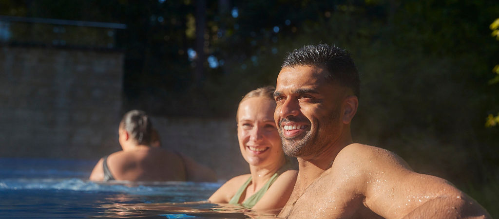 Spa therpaist leading a Sound Bathing Session with guests sleeping in a calming space.