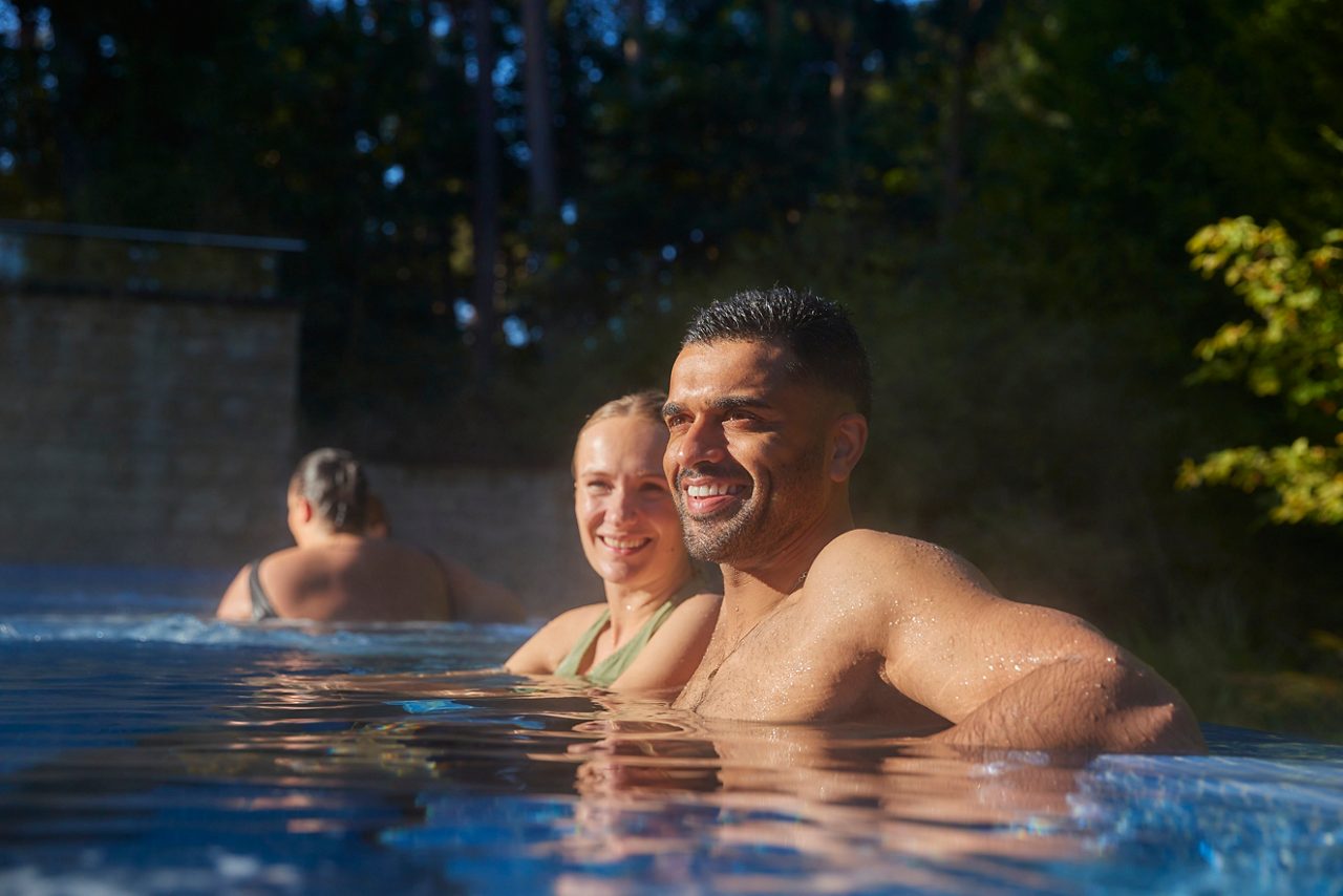 Couple soaking in an outdoor pool.