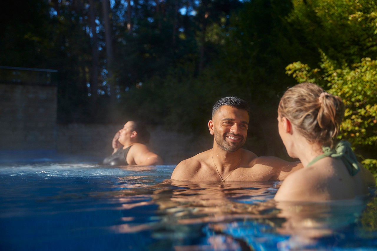 Woman snuggled in a large cocoon chair.