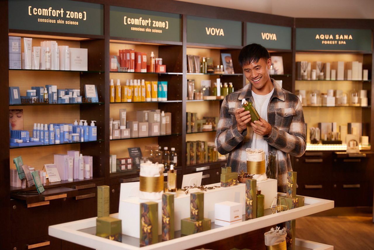 A man looking at a spa product in a spa retail shop