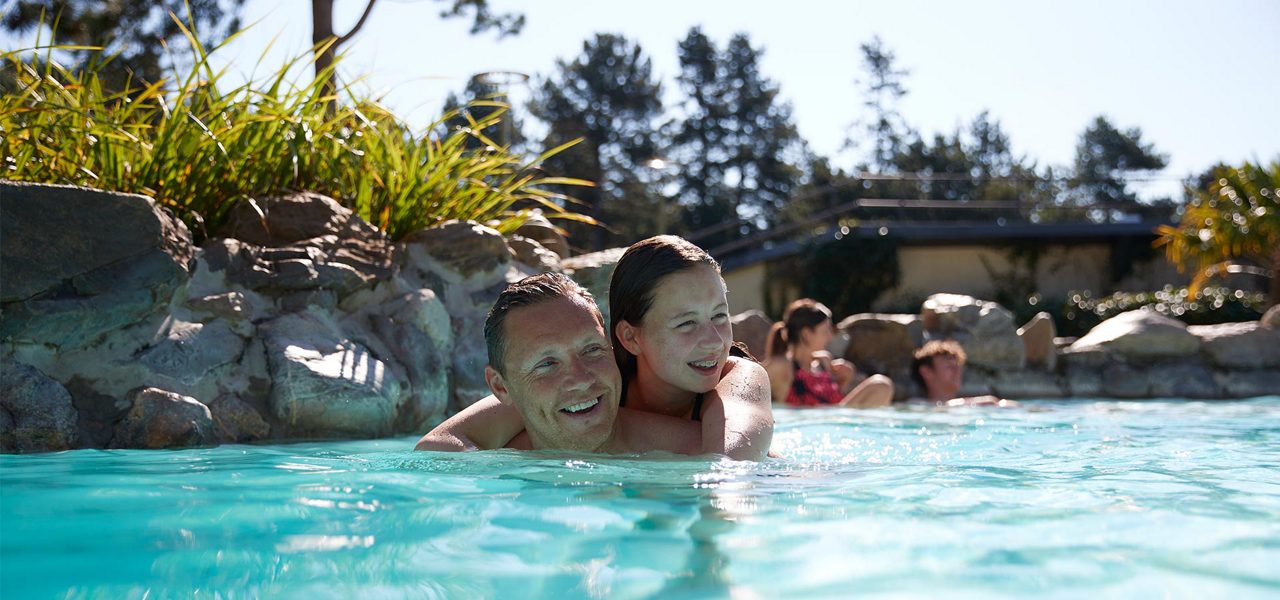 Father and daughter splashing in the Subtropical Swimming Paradise