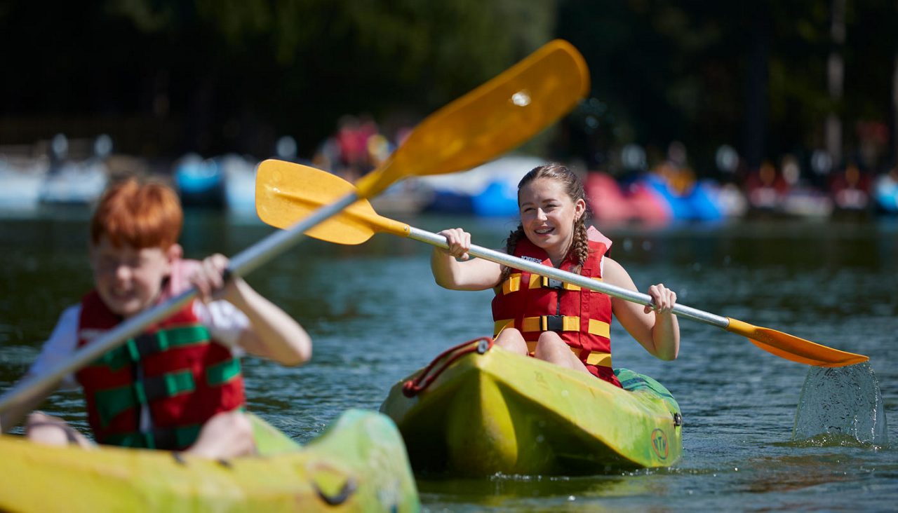 children kayaking on the lake