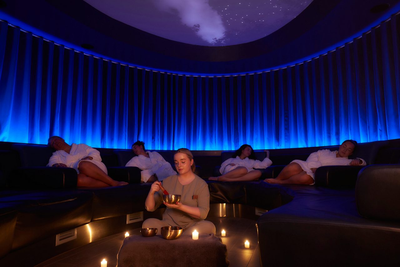 Spa therapist leading a Sound Bathing Session.