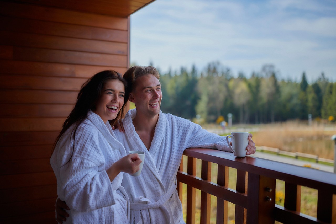 couple on the apartment balcony looking at the view