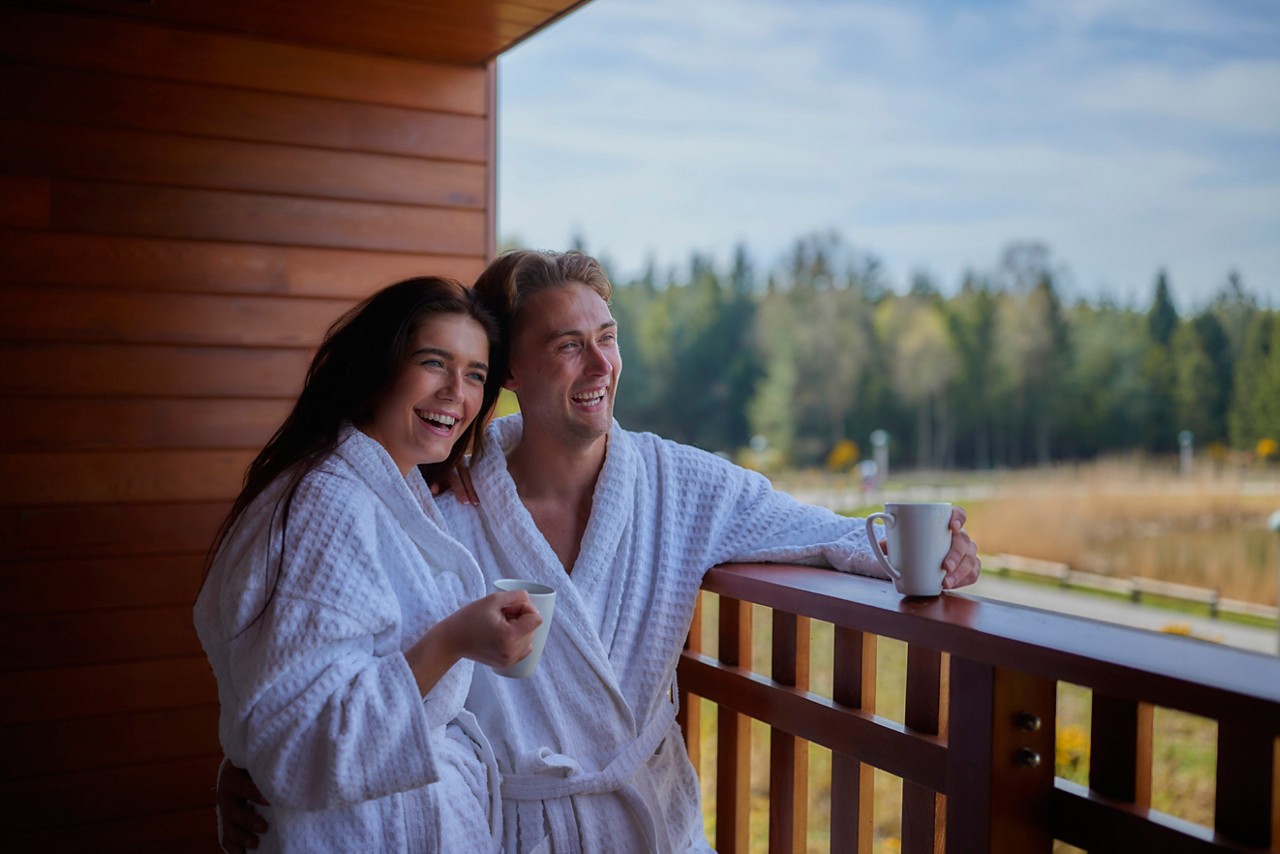 couple on the apartment balcony looking at the view