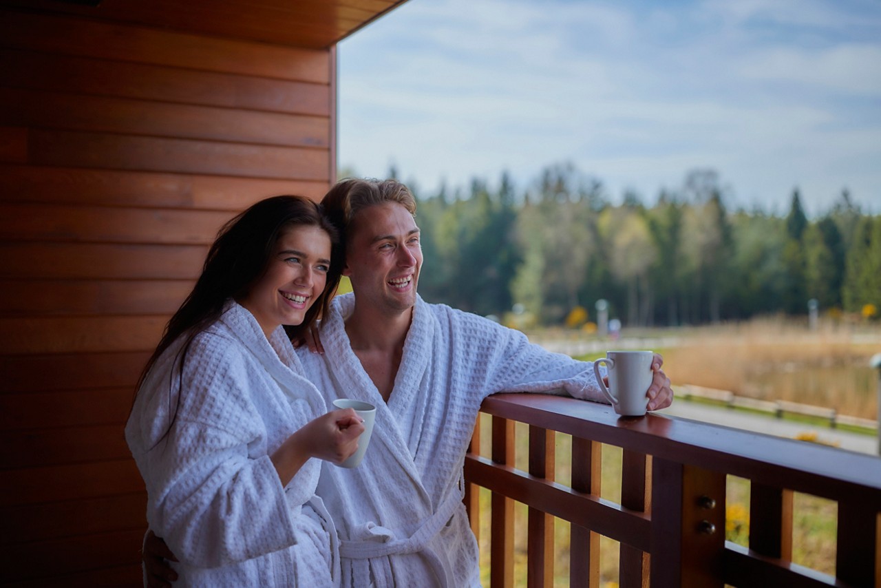couple on the apartment balcony looking at the view