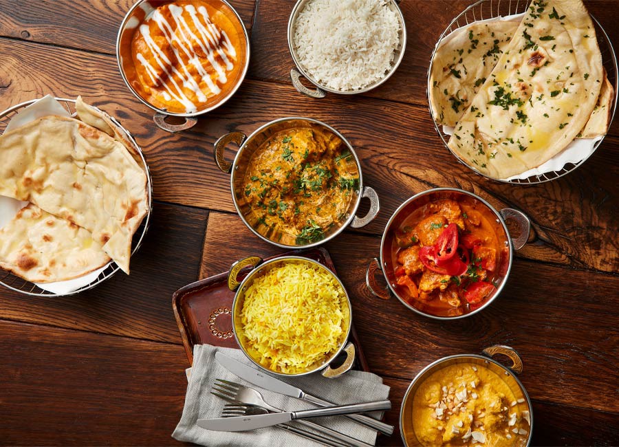 Selection of colourful curry dishes.