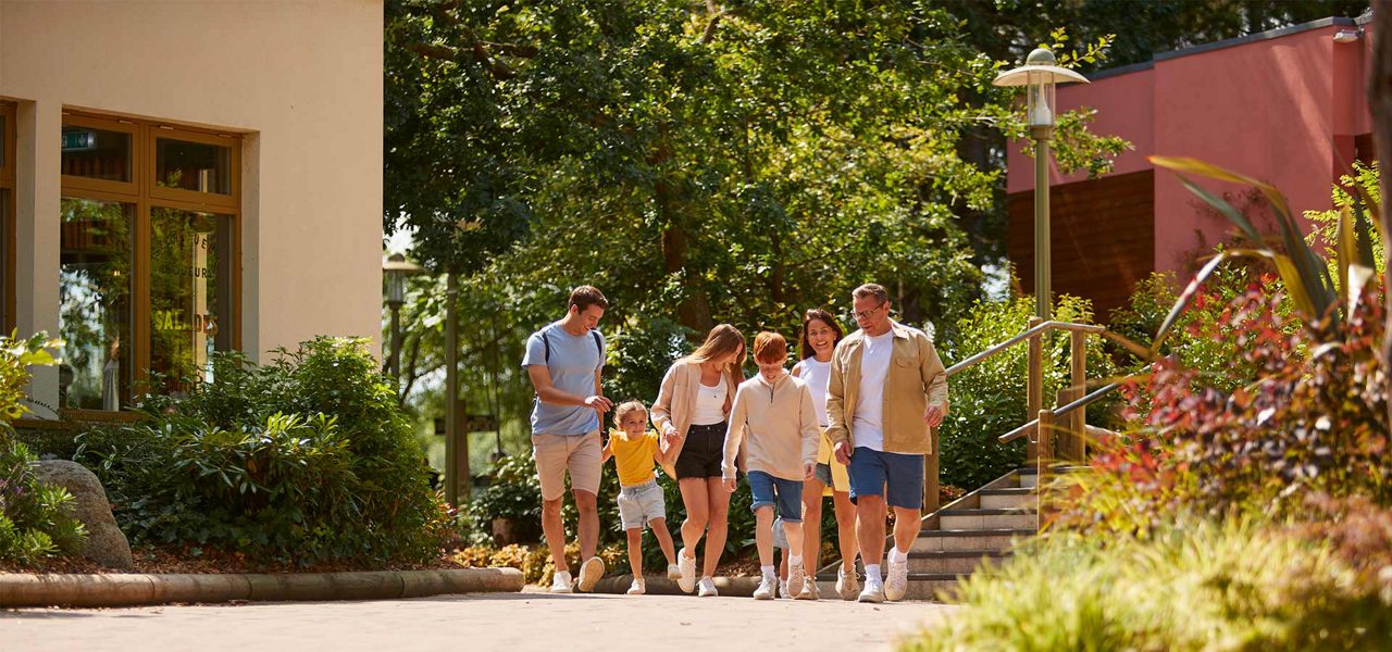 A large family walking through the village square together.