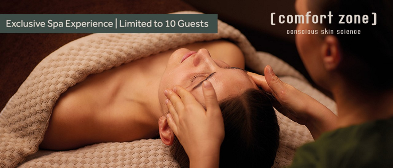 Promotional banner showing a luxury facial treatment with text reading ‘Exclusive Spa Experience | Limited to 10 Guests’ and ‘[ comfort zone ] – conscious skin science.
