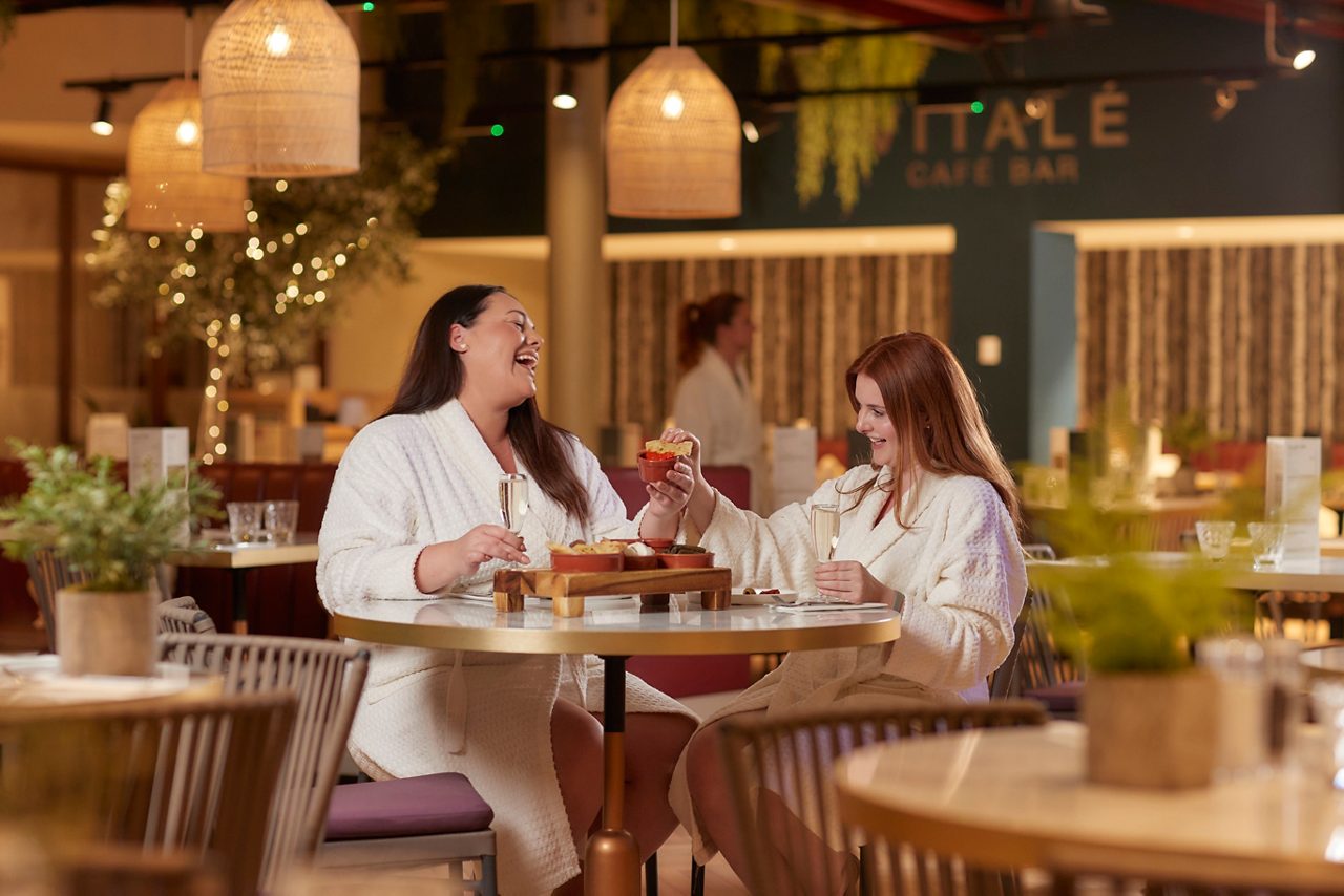 Two women eating in the Vitale Cafe Bar.