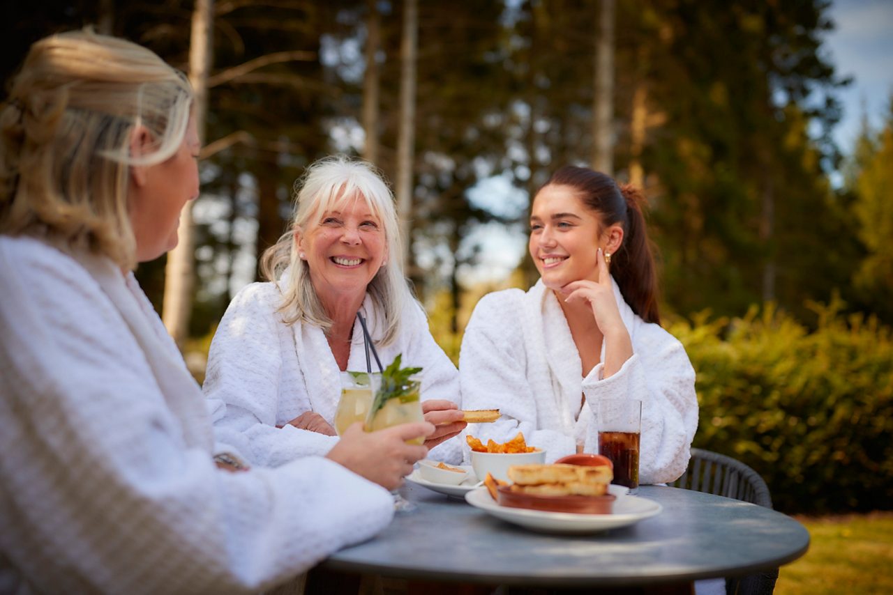 grandma, mum and daughter having lunch outside