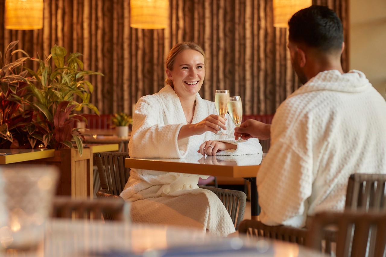 Couple sitting in the Vitalé Café Bar drinking champagne.