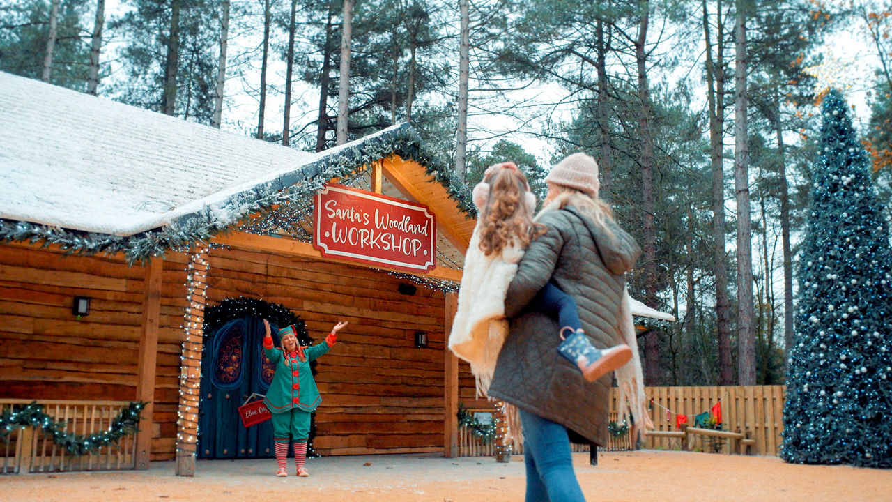 Mother and her daughter walking around Santa's woodland village.